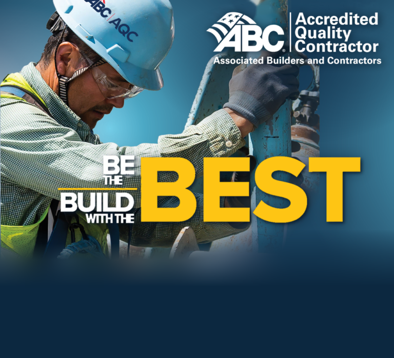 Construction worker with ABC accreditation and safety gear at work site.