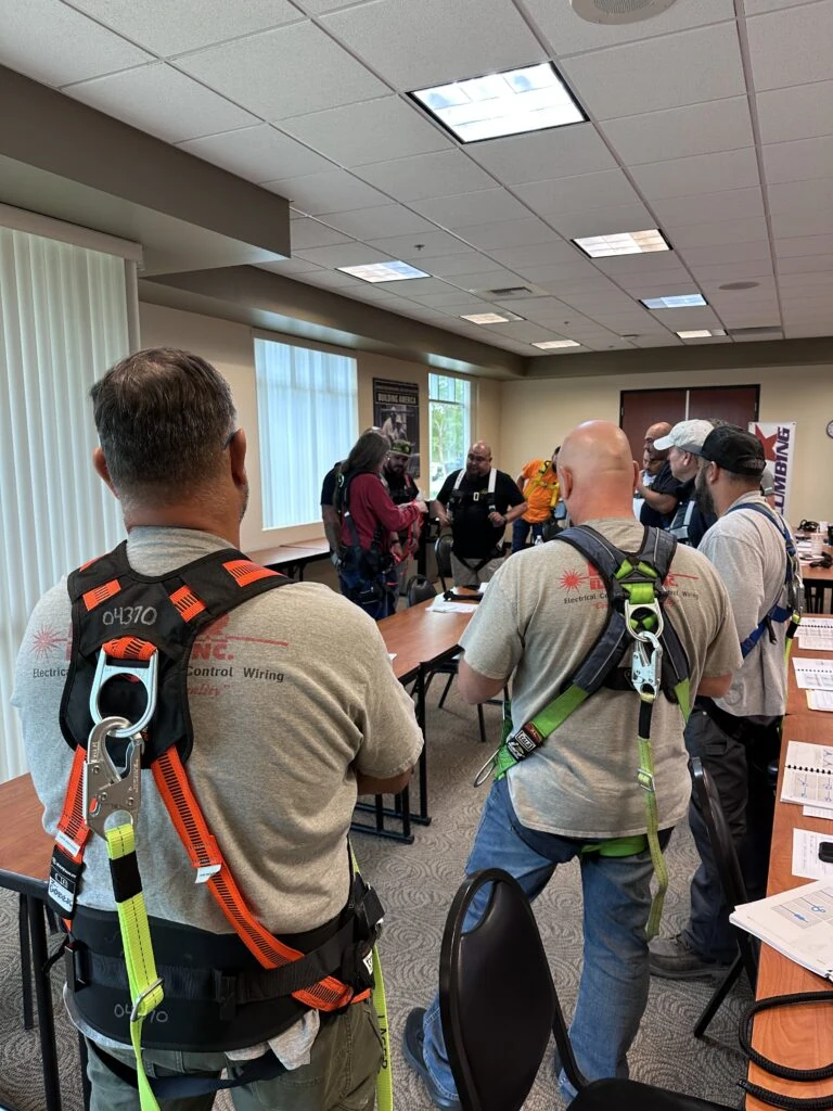 Group of construction workers attending safety training in a classroom setting.