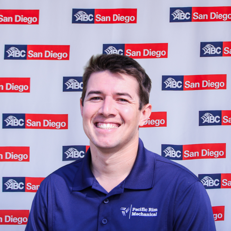 Professional headshot of a man in a polo shirt
