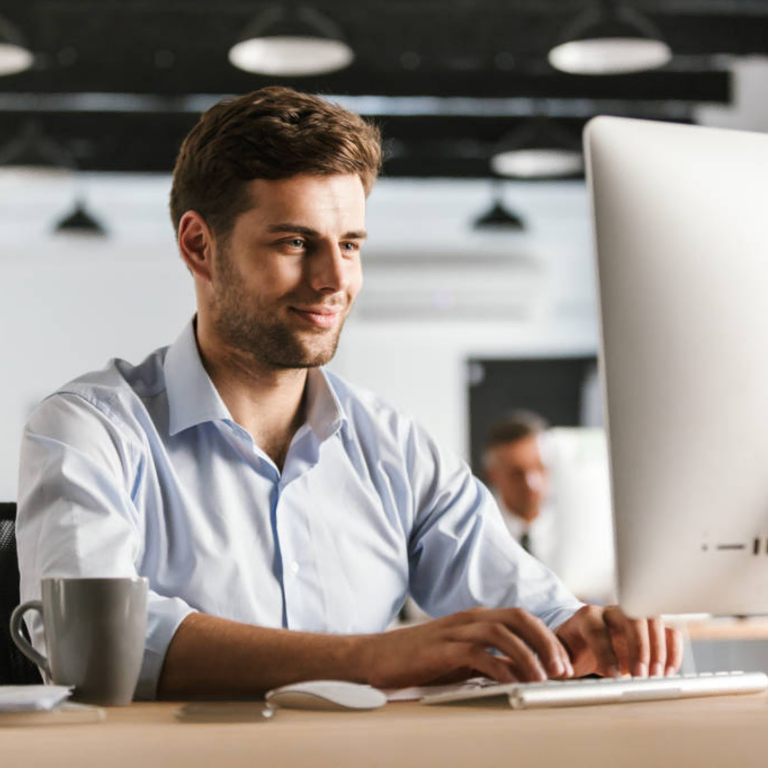 Man working at a desktop computer in an office