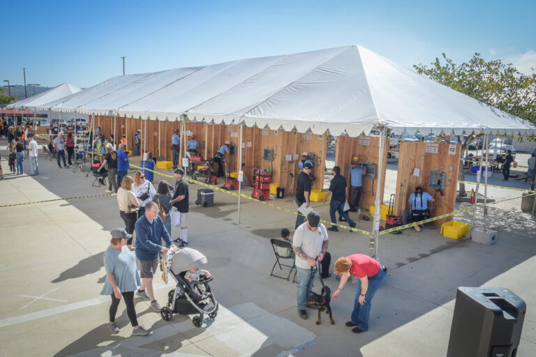People attending a construction skills event at ABCSD with booths and activities.