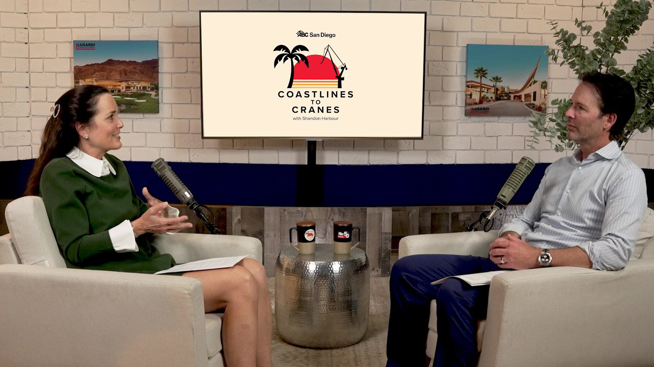 Man and woman recording the Coastlines to Cranes podcast on a set
