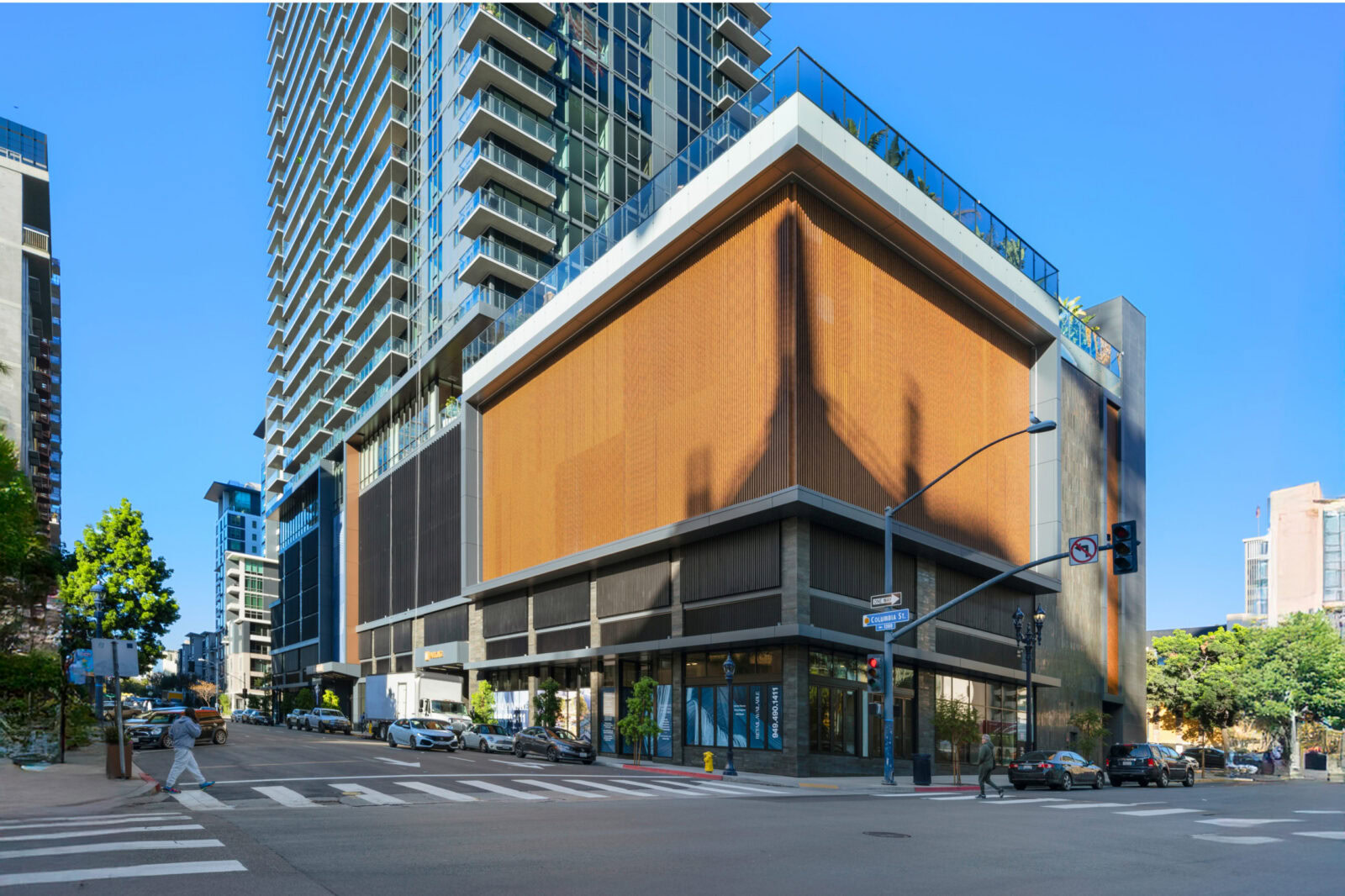 Contemporary commercial building with glass and wood facade in urban setting.