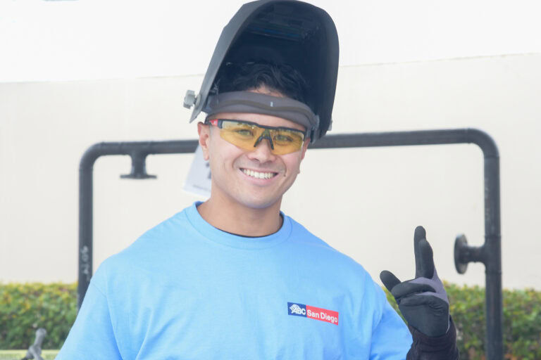 Young man welding with safety gear at the Local Craft Championship event.