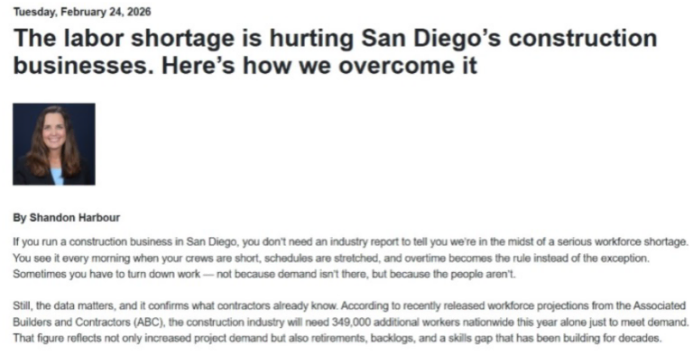Construction workers on site with building materials and equipment in San Diego.